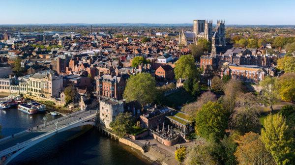 A view of a British town, featuring a bridge and a cathedral